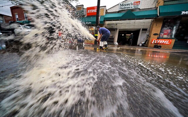 Water is pumped from the basement of a business on Noblestown road in Oakdale, Pennsylvania, during clean up from flooding after downpours and high winds from the remnants of Hurricane Ida hit the area September 1, 2021. (AP Photo/Gene J. Puskar) Water is pumped from the basement of a business on Noblestown road in Oakdale, Pennsylvania, during clean up from flooding after downpours and high winds from the remnants of Hurricane Ida hit the area September 1, 2021. (AP Photo/Gene J. Puskar)