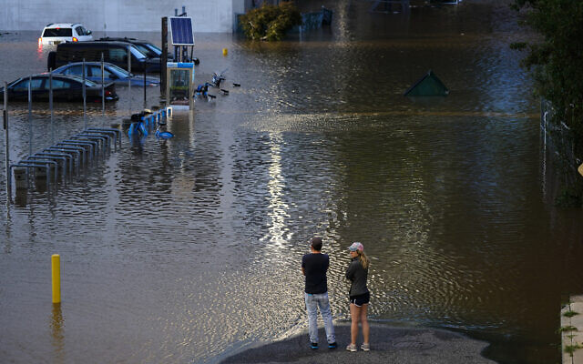 People view a flooded street in Philadelphia, on Thursday, September 2, 2021, in the aftermath of downpours and high winds from the remnants of Hurricane Ida that hit the area. (AP Photo/Matt Rourke)