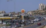A general view of a petrol station on the main highway that links the Capital Beirut to south Lebanon as cars come from every direction to try and fill their tanks with gasoline, in the coastal town of Jiyeh, south of Beirut, Lebanon, Friday, Sept. 3, 2021 (AP Photo/ Hassan Ammar)