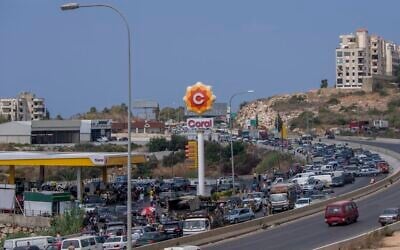 A general view of a petrol station on the main highway that links the Capital Beirut to south Lebanon as cars come from every direction to try and fill their tanks with gasoline, in the coastal town of Jiyeh, south of Beirut, Lebanon, Friday, Sept. 3, 2021 (AP Photo/ Hassan Ammar)