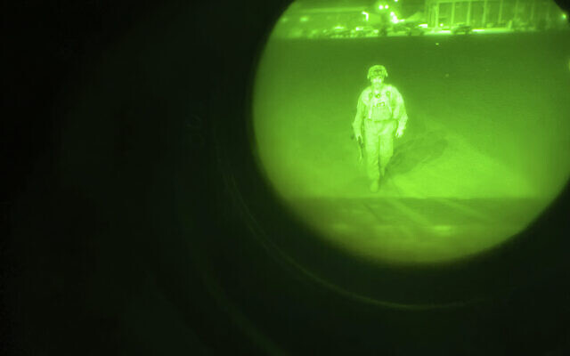 In this August 30, 2021, image made through a night vision scope and provided by the US Army, Maj. Gen. Chris Donahue, commander of the US Army 82nd Airborne Division, XVIII Airborne Corps, boards a C-17 cargo plane at Hamid Karzai International Airport in Kabul, Afghanistan, as the final American service member to depart the country. (Master Sgt. Alexander Burnett/US Army via AP, File)