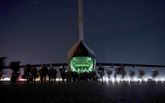 In this August 30, 2021, file photo provided by the US Air Force, soldiers, assigned to the 82nd Airborne Division, prepare to board a US Air Force C-17 Globemaster III aircraft at Hamid Karzai International Airport in Kabul, Afghanistan. (Senior Airman Taylor Crul/US Air Force via AP, File)