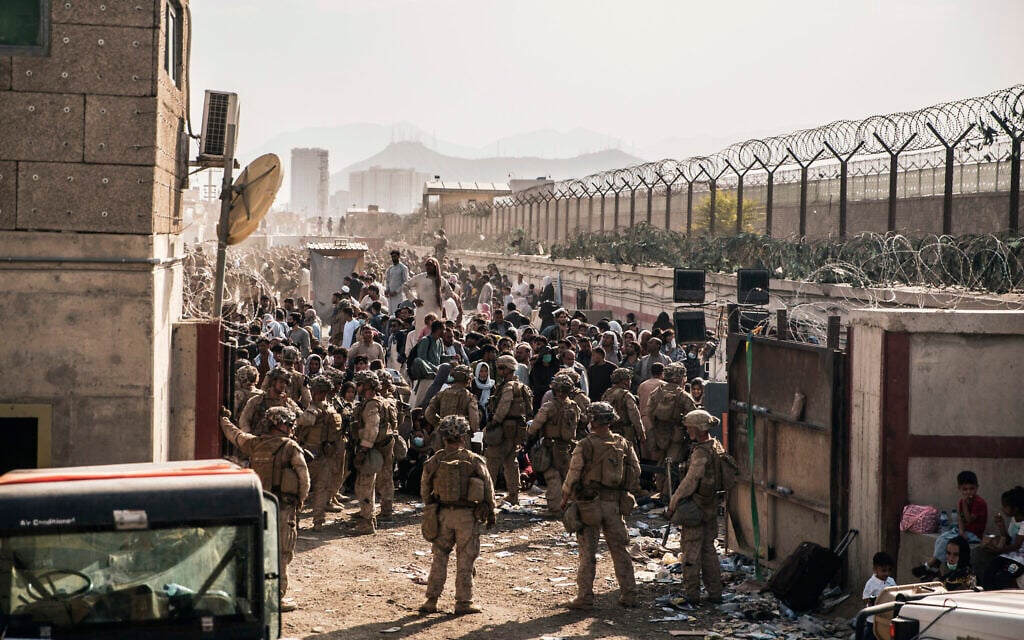 In this August 21, 2021,file photo provided by the US Marines, US Marines with Special Purpose Marine Air-Ground Task Force - Crisis Response - Central Command, provide assistance at an evacuation control checkpoint during an evacuation at Hamid Karzai International Airport in Kabul, Afghanistan. (Staff Sgt. Victor Mancilla/US Marine Corps via AP, File) In this August 21, 2021,file photo provided by the US Marines, US Marines with Special Purpose Marine Air-Ground Task Force - Crisis Response - Central Command, provide assistance at an evacuation control checkpoint during an evacuation at Hamid Karzai International Airport in Kabul, Afghanistan. (Staff Sgt. Victor Mancilla/US Marine Corps via AP, File)