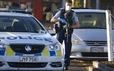 Armed police stand outside a supermarket in Auckland, New Zealand, Saturday, Sept. 4, 2021. New Zealand authorities say they shot and killed a violent extremist, Friday Sept. 3, after he entered a supermarket and stabbed and injured six shoppers. (AP Photo/Brett Phibbs)