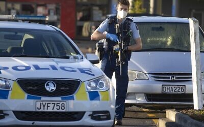 Armed police stand outside a supermarket in Auckland, New Zealand, Saturday, Sept. 4, 2021. New Zealand authorities say they shot and killed a violent extremist, Friday Sept. 3, after he entered a supermarket and stabbed and injured six shoppers. (AP Photo/Brett Phibbs)