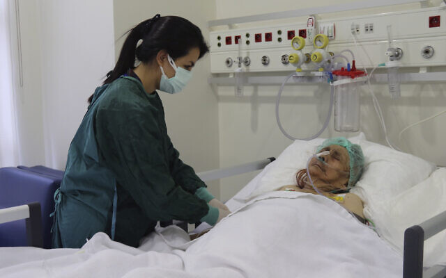 A nurse monitors Ayse Karatay at the City Hospital in Eskisehir, western Turkey, on September 4, 2021. (IHA via AP)
