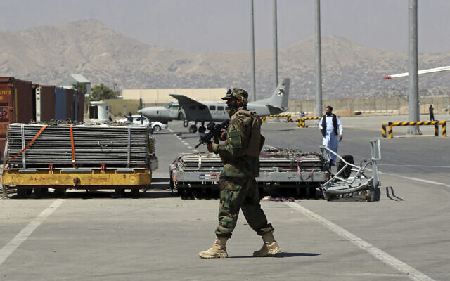 A Taliban soldier walks on the tarmac at Hamid Karzai International Airport in Kabul, Afghanistan, September 5, 2021.  (AP Photo/Wali Sabawoon)