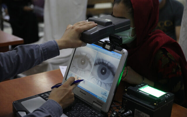 An employee scans the eyes of a woman for biometric data needed to apply for a passport, at the passport office in Kabul, Afghanistan, June 30, 2021. (AP Photo/Rahmat Gul, File) An employee scans the eyes of a woman for biometric data needed to apply for a passport, at the passport office in Kabul, Afghanistan, June 30, 2021. (AP Photo/Rahmat Gul, File)