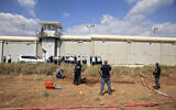 Police officers and prison guards inspect the scene of a prison escape outside the Gilboa prison in Northern Israel, on Monday, September 6, 2021. (AP/Sebastian Scheiner)