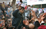 Zakaria Zubeidi, then-leader in the Al Aqsa Martyrs Brigade in the West Bank, is carried by supporters during a presidential elections campaign rally in support of Mahmoud Abbas, in the West Bank town of Jenin, on December 30, 2004. (Nasser Nasser/AP)