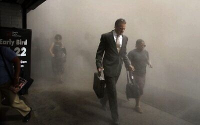 Pedestrians flee the area of New York's World Trade Center in lower Manhattan on Tuesday, Sept. 11, 2001. (AP Photo/Amy Sancetta)
