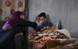 Tareq Zubeidi, 15, rests at his house, in the West Bank village of Silat ad-Dhahr, Tuesday, August 31, 2021. (AP/Majdi Mohammed)