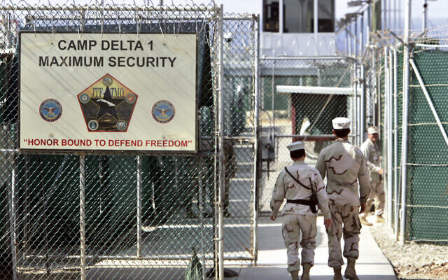 In this June 27, 2006 file photo, reviewed by a US Department of Defense official, US military guards walk within Camp Delta military-run prison, at the Guantanamo Bay US Naval Base, Cuba. (AP/Brennan Linsley, File) In this June 27, 2006 file photo, reviewed by a US Department of Defense official, US military guards walk within Camp Delta military-run prison, at the Guantanamo Bay US Naval Base, Cuba. (AP/Brennan Linsley, File)