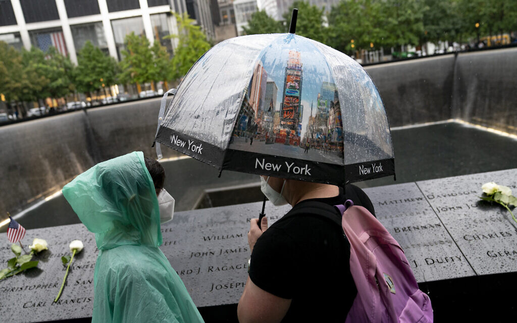 Visitors browse the south pool at the National September 11 Memorial & Museum, Sept. 9, 2021, in New York. (AP Photo/John Minchillo)