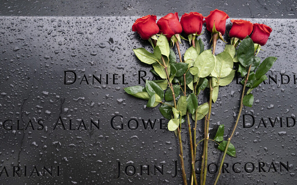 Red roses rest against the names of the fallen on the south pool at the National September 11 Memorial & Museum, Sept. 9, 2021, in New York. (AP Photo/John Minchillo)
