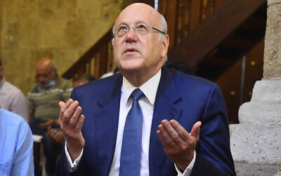 In this photo released by Lebanese government, Lebanese Prime Minister Najib Mikati, prays as he attends Friday prayers, at a mosque in downtown Beirut, Lebanon Sept 10, 2021. (Dalati Nohra/Lebanese Official Government via AP)