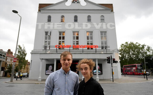 Actors Patsy Ferran, right and Luke Thallon, stars of the play Camp Siegfried, pose for a photographer in front of the Old Vic theatre in London, Friday, Sept. 10, 2021. (AP Photo/Frank Augstein)