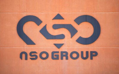 FILE - In this Tuesday, Aug. 24, 2021, file photo, a logo adorns a wall on a branch of the Israeli NSO Group company, near the southern Israeli town of Sapir. Apple released an emergency security software patch to fix a vulnerability that an internet watchdog group says allowed spyware from the world’s most infamous hacker-for-hire firm, NSO Group, to infect the iPhone of a Saudi activist without any user interaction. (AP Photo/Sebastian Scheiner, File)