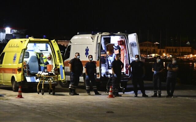 Paramedics wait next to ambulances at Pythagorio port, on the eastern Aegean island of Samos, Greece, late Monday, Sept. 13, 2021, after the crash of a private plane from Israel that killed a prosecution witness in the corruption trial of former prime minister Benjamin Netanyahu. (AP Photo/Michael Svarnias)