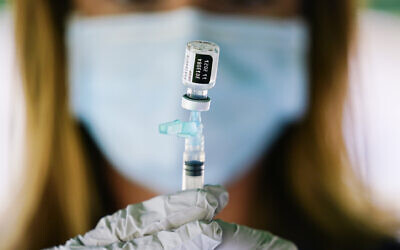 A syringe is prepared with the Pfizer COVID-19 vaccine at a clinic at the Reading Area Community College in Reading, Pennsylvania, September 14, 2021. (AP Photo/Matt Rourke, File)