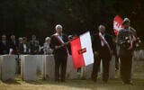 People with Polish flags attend a wreath laying ceremony to commemorate the Nazi German invasion of Poland and the beginning of World War II at the British War Cemetery in Berlin, Germany, September 1, 2019. (AP Photo/Markus Schreiber, File)