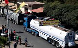 A convoy of tanker trucks carrying Iranian diesel across the border from Syria into Lebanon arrives at the eastern town of al-Ain, Lebanon, on September 16, 2021. (AP/ Bilal Hussein)