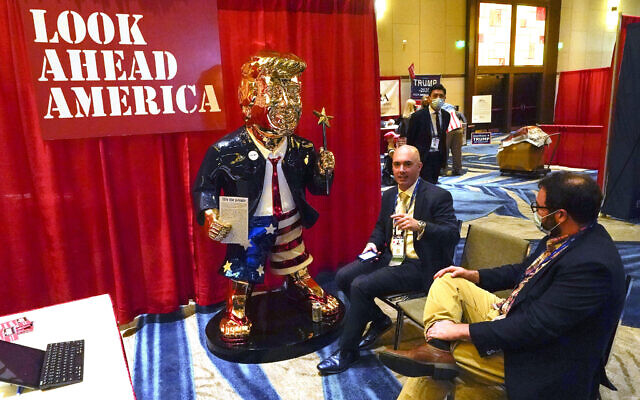 In this Feb. 26, 2021, file photo, Look Ahead America sponsor Matt Braynard, center, talks to conference attendees at his booth in the merchandise show with a statue of former president Donald Trump at the Conservative Political Action Conference (CPAC) in Orlando, Fla. (AP Photo/John Raoux, File) In this Feb. 26, 2021, file photo, Look Ahead America sponsor Matt Braynard, center, talks to conference attendees at his booth in the merchandise show with a statue of former president Donald Trump at the Conservative Political Action Conference (CPAC) in Orlando, Fla. (AP Photo/John Raoux, File)