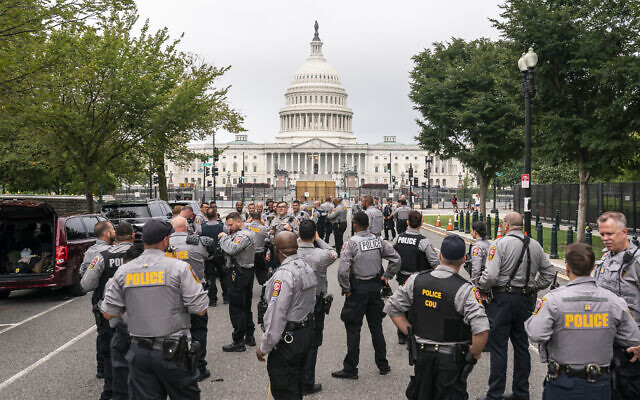 Police stage at a security fence ahead of a rally near the US Capitol in Washington, DC, on September 18, 2021. (AP Photo/Nathan Howard)