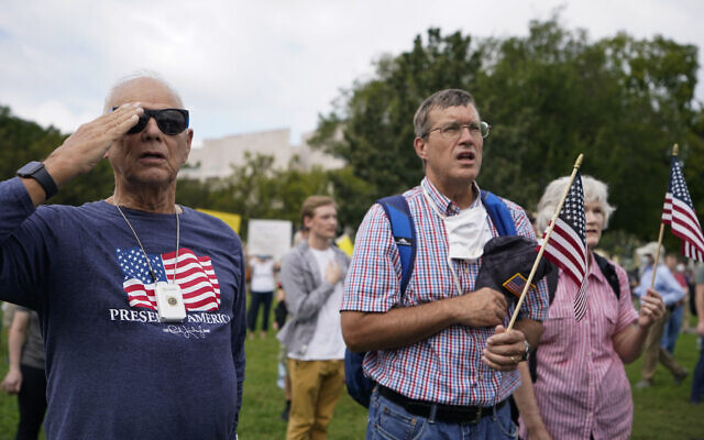 People stand as the national anthem plays during a rally near the US Capitol in Washington, Saturday, Sept. 18, 2021.  (AP/Brynn Anderson)
