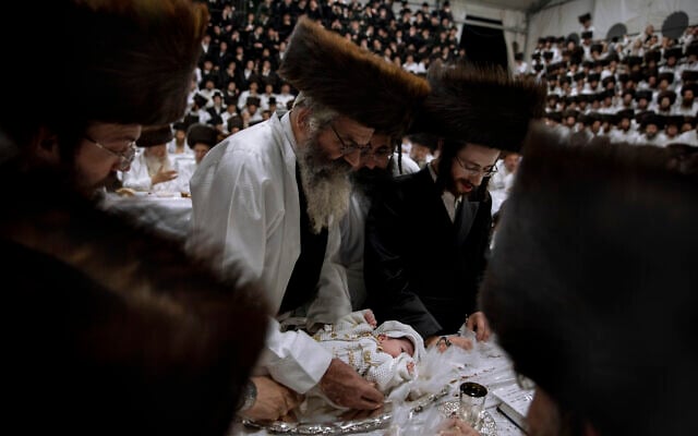 Yaakov Tabersky, right, presented his firstborn son, Yossef on a silver platter to Jewish priests from the Lelov Hassidic dynasty, during the "Pidyon Haben" ceremony in Beit Shemesh, Israel, on Thursday, September 16, 2021. The Pidyon Haben, or redemption of the firstborn son, is a Jewish ceremony hearkening back to the biblical exodus from Egypt. (AP Photo/Oded Balilty)