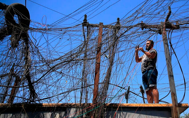 Muqtada Haider turns the switches to transfer electricity to private homes in Baghdad, Iraq, on Friday, September 10, 2021. (AP Photo/Hadi Mizban) Muqtada Haider turns the switches to transfer electricity to private homes in Baghdad, Iraq, on Friday, September 10, 2021. (AP Photo/Hadi Mizban)