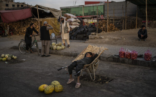 An Afghan boy sits on a wheelbarrow as he waits for customers at a street fruit and vegetable market in Kabul, Afghanistan, September 22, 2021. (AP Photo/Bernat Armangue) An Afghan boy sits on a wheelbarrow as he waits for customers at a street fruit and vegetable market in Kabul, Afghanistan, September 22, 2021. (AP Photo/Bernat Armangue)