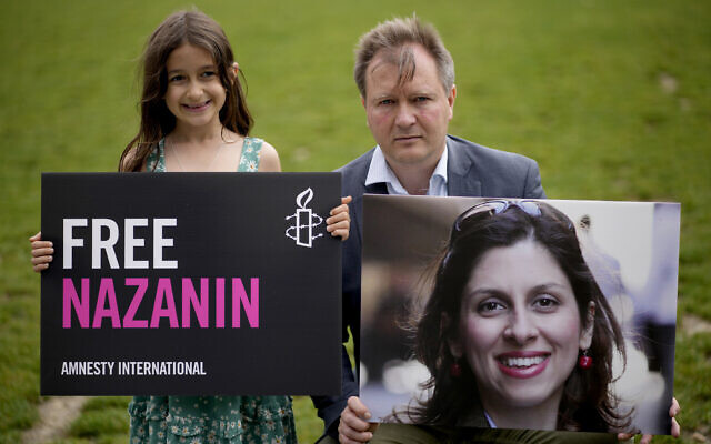 Richard Ratcliffe, the husband of imprisoned British-Iranian Nazanin Zaghari-Ratcliffe and their seven year old daughter Gabriella pose for the media backdropped by the scaffolded Houses of Parliament and the Elizabeth Tower, known as Big Ben, in Parliament Square, London, to mark the 2,000 days she has been detained in Iran, September 23, 2021. (AP Photo/Matt Dunham) Richard Ratcliffe, the husband of imprisoned British-Iranian Nazanin Zaghari-Ratcliffe and their seven year old daughter Gabriella pose for the media backdropped by the scaffolded Houses of Parliament and the Elizabeth Tower, known as Big Ben, in Parliament Square, London, to mark the 2,000 days she has been detained in Iran, September 23, 2021. (AP Photo/Matt Dunham)