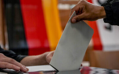 A man casts his ballot for the German elections in a polling station in Berlin, Germany, September 26, 2021. (AP Photo/ Michael Probst)