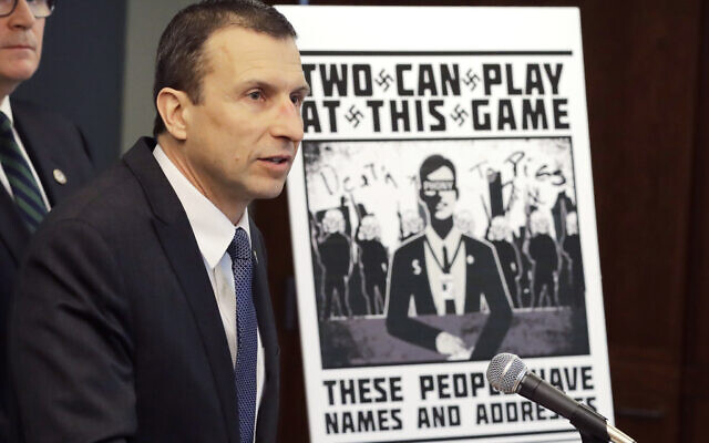 Raymond Duda, US special agent in charge in Seattle, speaks as he stands next to a poster that was mailed earlier in the year to the home of Chris Ingalls, an investigative reporter with KING-TV in Seattle, during a news conference in Seattle, February 26, 2020. (AP Photo/Ted S. Warren, File)