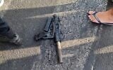 An Uzi submachine gun is seen on the floor near the Tel Aviv promanade, after a suspect from Jaffa allegedly threatened passersby. (courtesy)