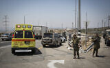 Illustrative: An ambulance and IDF troops are seen on Route 443 near Beit Horon, on August 15, 2015. (Hadas Parush/Flash90)