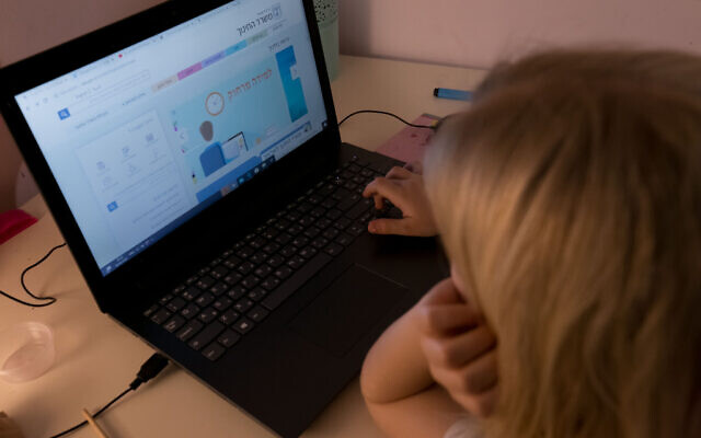 Illustrative: An Israeli girl is seen participating in remote learning from home in Moshav Haniel, on March 18, 2020. (Chen Leopold/Flash90) Illustrative: An Israeli girl is seen participating in remote learning from home in Moshav Haniel, on March 18, 2020. (Chen Leopold/Flash90)