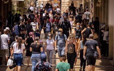 People shop at the Alrov Mamilla Avenue in Jerusalem on August 11, 2021. (Yonatan Sindel/Flash90)