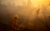 Illustrative: Firefighters try to extinguish a fire at moshav Givat Ye'arim outside Jerusalem on August 16, 2021. (Olivier Fitoussi/Flash90)