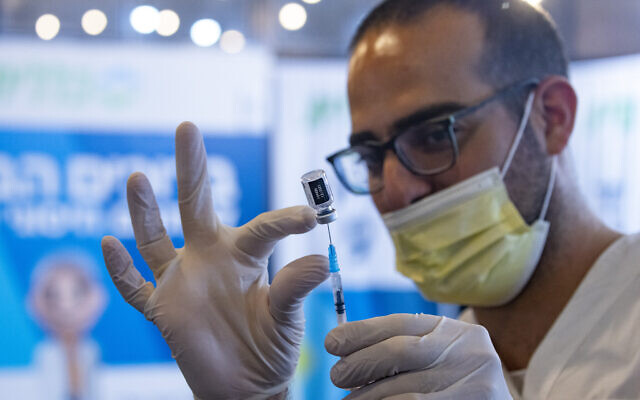 A syringe is prepared with the Pfizer COVID-19 vaccine at a clinic in Jerusalem, September 1, 2021. (Olivier Fitoussi/ Flash90) A syringe is prepared with the Pfizer COVID-19 vaccine at a clinic in Jerusalem, September 1, 2021. (Olivier Fitoussi/ Flash90)