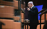 Opposition leader MK Benjamin Netanyahu addresses the Knesset from a special COVID-19 quarantine area in the guest gallery during a plenum session on the state budget, September 2, 2021. (Olivier Fitoussi/Flash90)