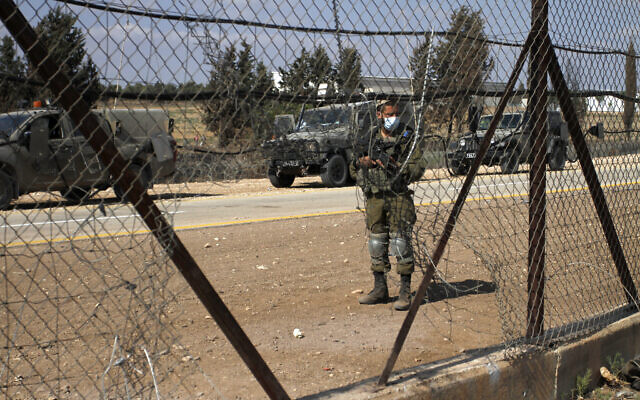 An Israeli soldier stands guard near the northern West Bank city of Jenin on September 6, 2021. (Nasser Ishtayeh/Flash90)