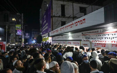 Jewish men wait outside a COVID-19 testing facility in Uman at the end of the Jewish holiday of Rosh Hashanah, on September 8, 2021. (Flash90)