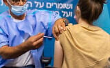 An Israeli woman receives a COVID-19 vaccine at a Clalit Health Services clinic in Jerusalem on September 9, 2021.  (Olivier Fitoussi/Flash90)