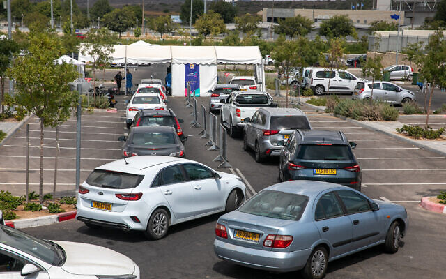 Health care workers take test samples at a drive-through coronavirus test center in Modi'in, on September 10 2021. (Yossi Aloni/Flash90) Health care workers take test samples at a drive-through coronavirus test center in Modi'in, on September 10 2021. (Yossi Aloni/Flash90)