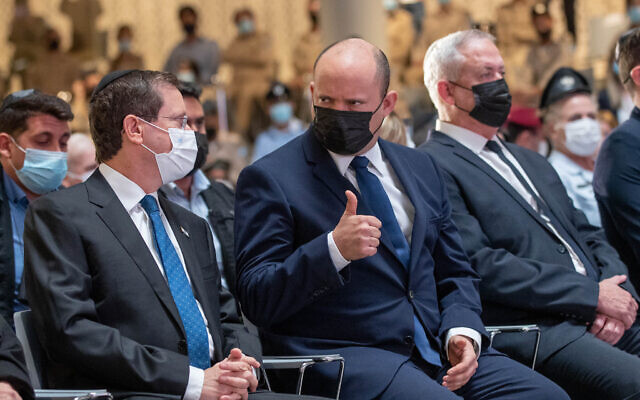 President Isaac Herzog (left), Prime Minister Naftali Bennett (center) and Defense Minister Benny Gantz attend a memorial ceremony for the fallen Israeli soldiers of the 1973 Yom Kippur War, at the National Hall of Remembrance, Mount Herzl, Jerusalem, September 19, 2021. (Ohad Zwigenberg/POOL) President Isaac Herzog (left), Prime Minister Naftali Bennett (center) and Defense Minister Benny Gantz attend a memorial ceremony for the fallen Israeli soldiers of the 1973 Yom Kippur War, at the National Hall of Remembrance, Mount Herzl, Jerusalem, September 19, 2021. (Ohad Zwigenberg/POOL)
