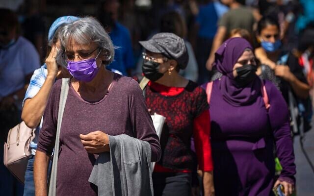 People wearing face masks shop at the Mahane Yehuda market in Jerusalem, on September 29, 2021. (Olivier Fitoussi/Flash90) People wearing face masks shop at the Mahane Yehuda market in Jerusalem, on September 29, 2021. (Olivier Fitoussi/Flash90)