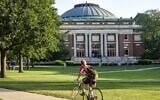 A student bikes across campus at the University of Illinois at Urbana-Champaign. (Jeffrey Greenberg/Universal Images Group via Getty Images/JTA)