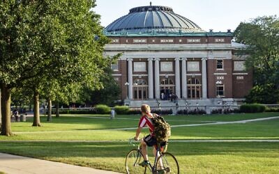 A student bikes across campus at the University of Illinois at Urbana-Champaign. (Jeffrey Greenberg/Universal Images Group via Getty Images/JTA)